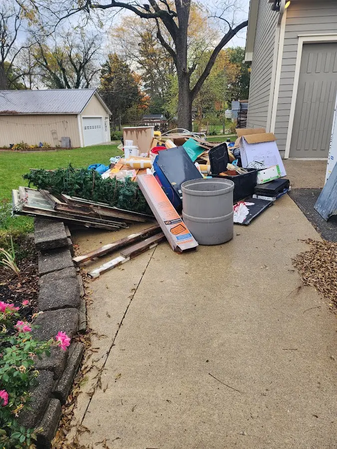 Dumpster being loaded with debris for Commercial Dumpster Rental in Wood Village